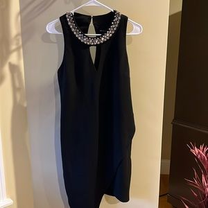 Beautiful black stretch cocktail dress with stone accent on neckline. Size XL